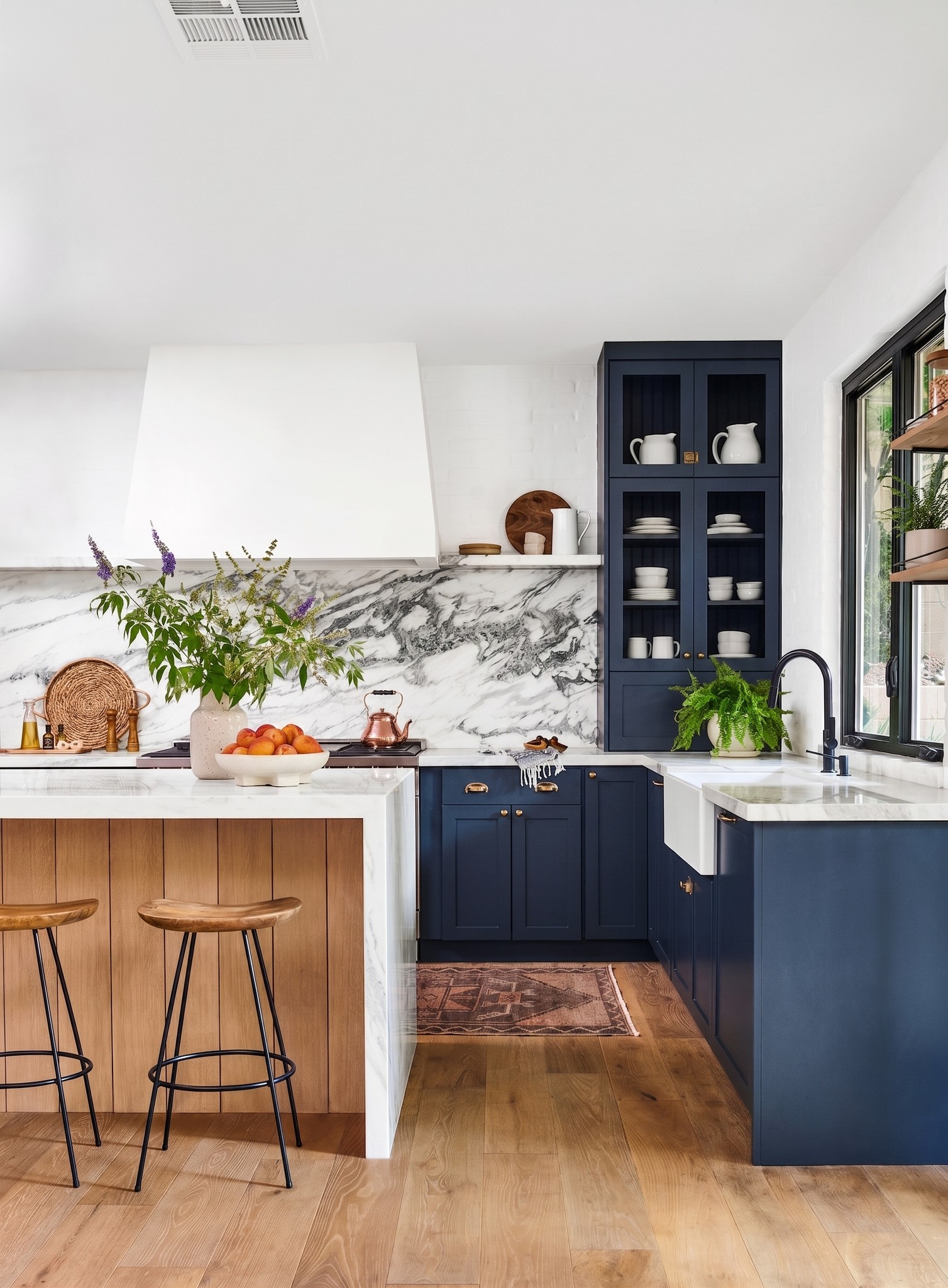 Navy and oak kitchen with a marble splashback and open shelving