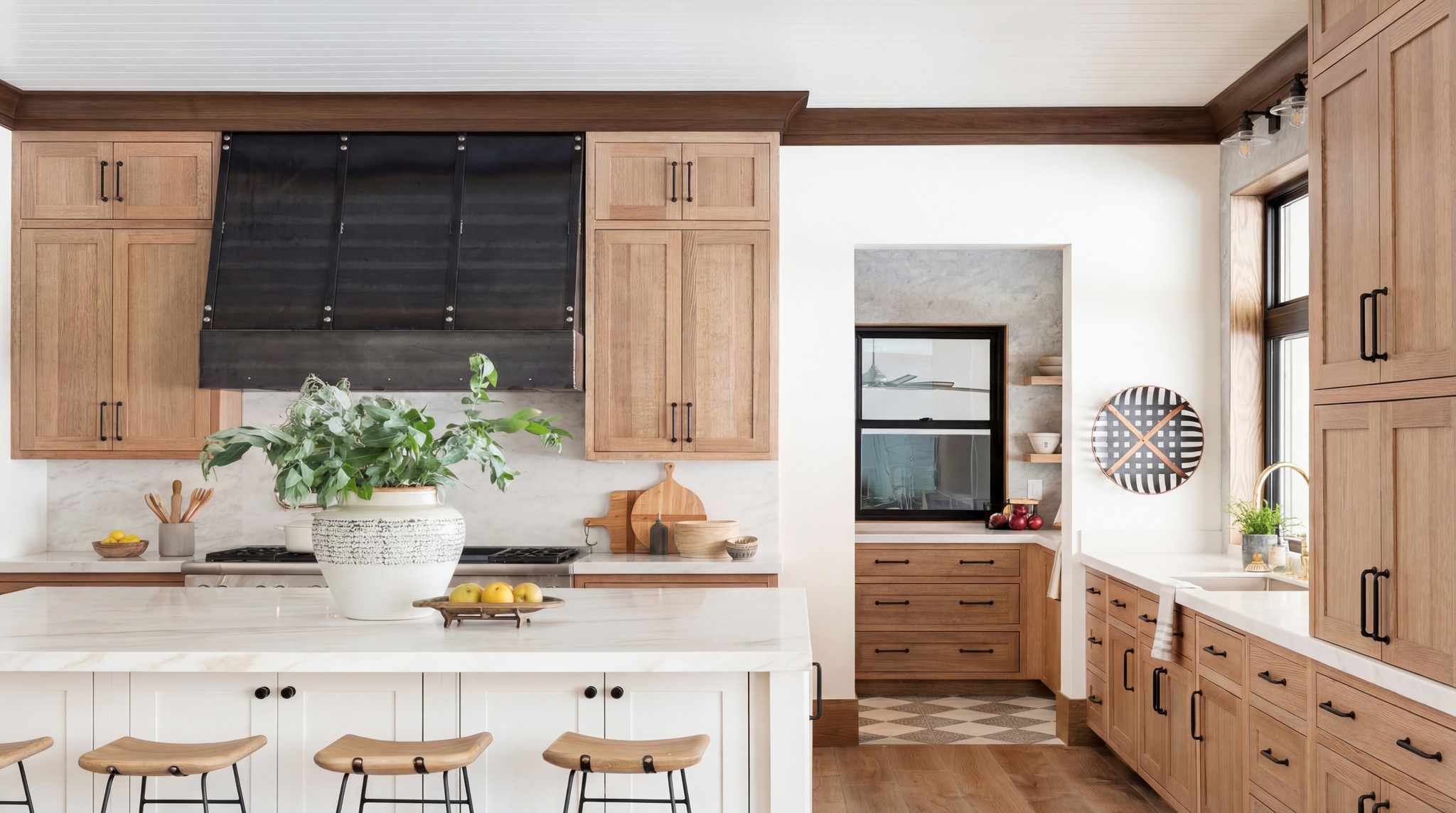 Oak kitchen with a black range hood, marble worktop and timber bar stools – Chiswick renovation