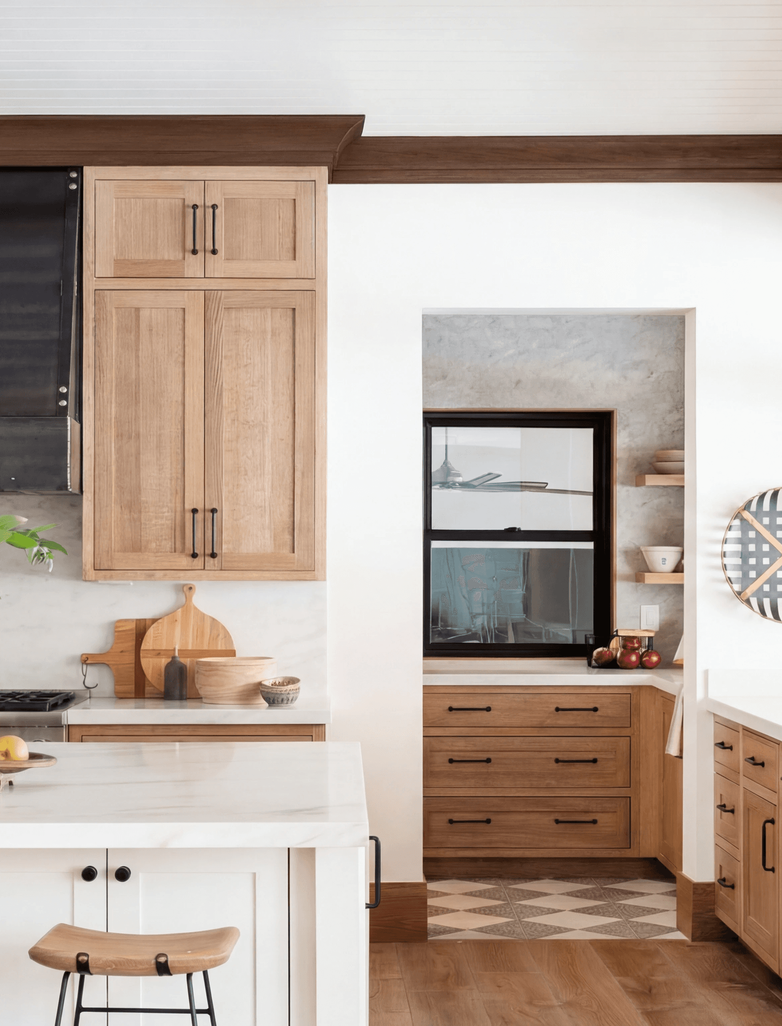Oak shaker kitchen with a tall larder unit and marble worktops