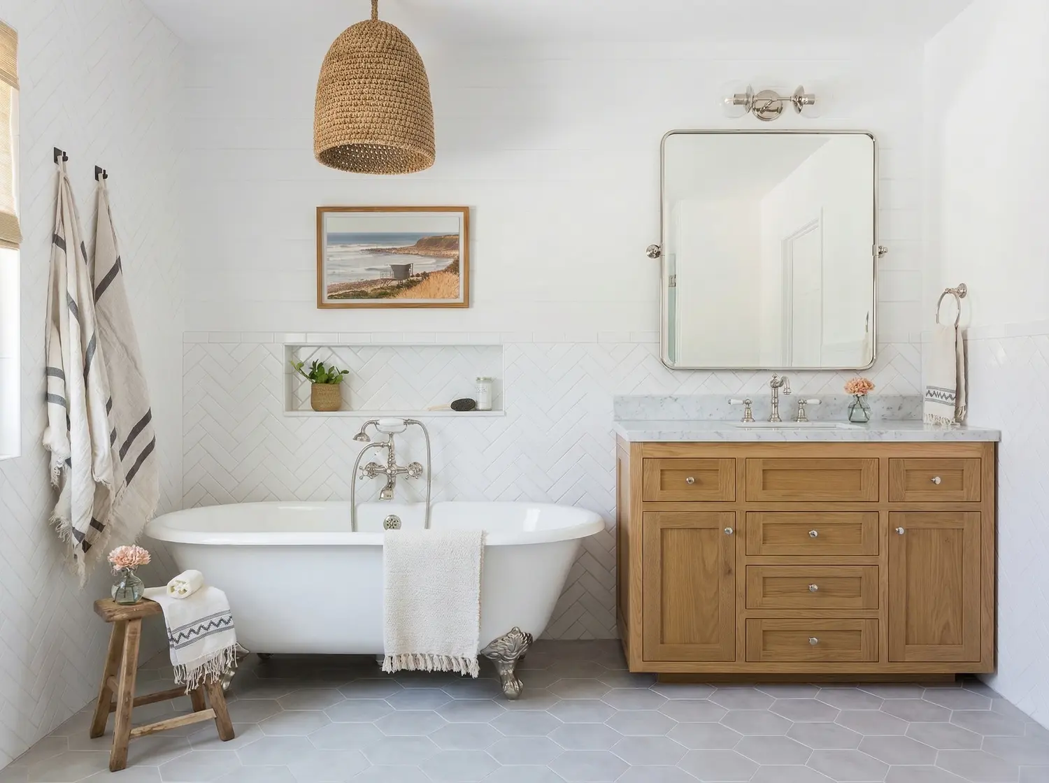 White bathroom with roll-top bath and oak vanity